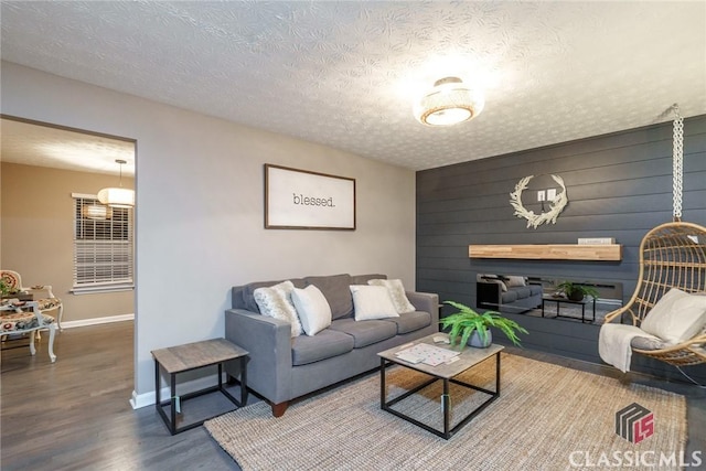 living room featuring a textured ceiling and hardwood / wood-style flooring