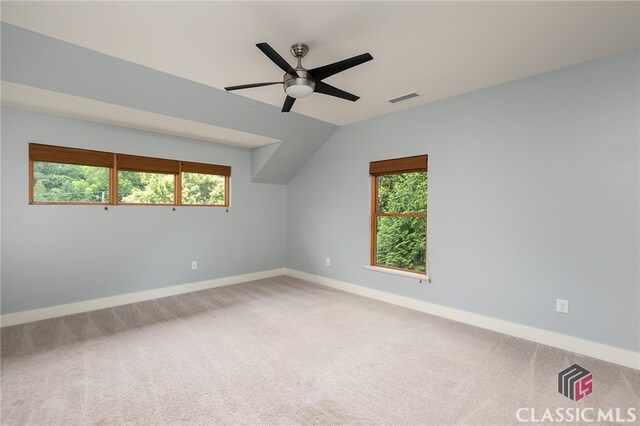 additional living space with carpet flooring, vaulted ceiling, plenty of natural light, and ceiling fan