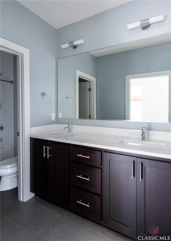 full bathroom with tile patterned floors, vanity, toilet, and shower / tub combination