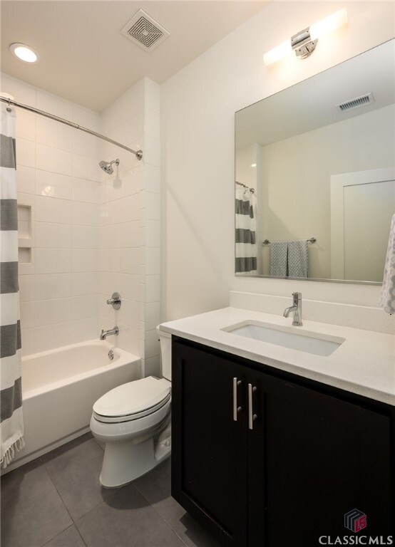 full bathroom with tile patterned flooring, vanity, toilet, and shower / bath combo