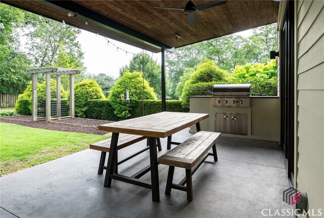 view of patio / terrace with an outdoor kitchen, ceiling fan, and a grill