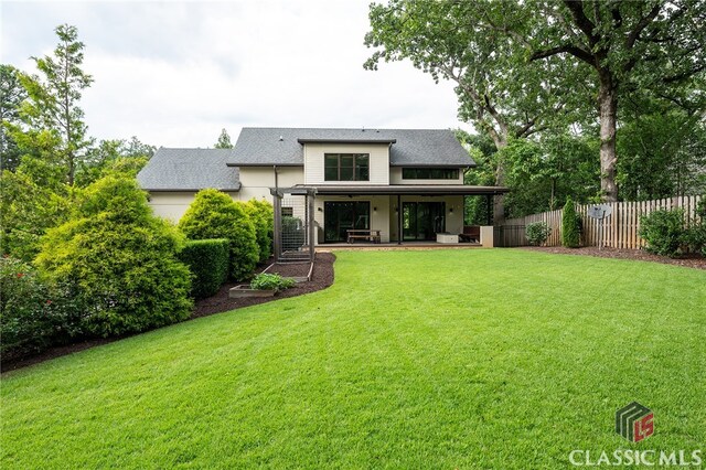 rear view of property with a lawn, a patio area, and a pergola