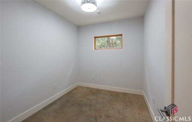 unfurnished room featuring concrete floors