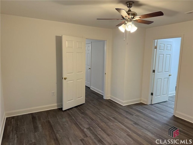 spare room featuring ceiling fan and dark hardwood / wood-style flooring