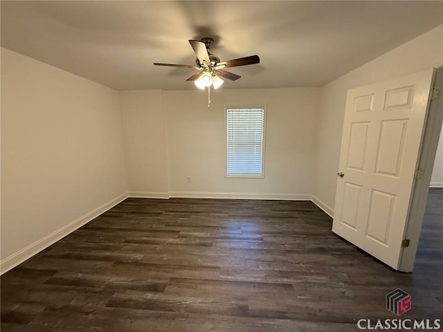 unfurnished room with dark hardwood / wood-style flooring and ceiling fan