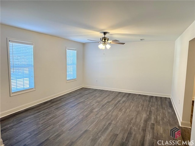 empty room with ceiling fan and dark wood-type flooring