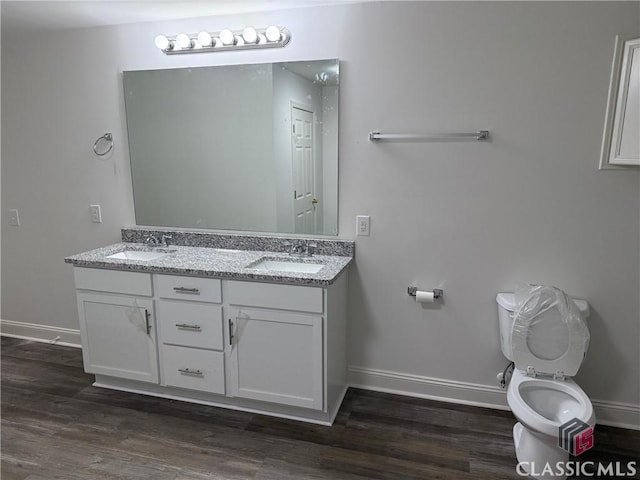 bathroom featuring hardwood / wood-style floors, vanity, and toilet