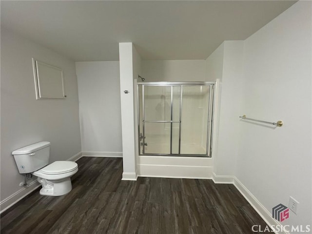 bathroom with shower / bath combination with glass door, toilet, and wood-type flooring