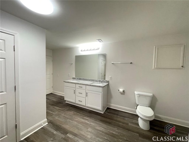 bathroom featuring hardwood / wood-style floors, vanity, and toilet