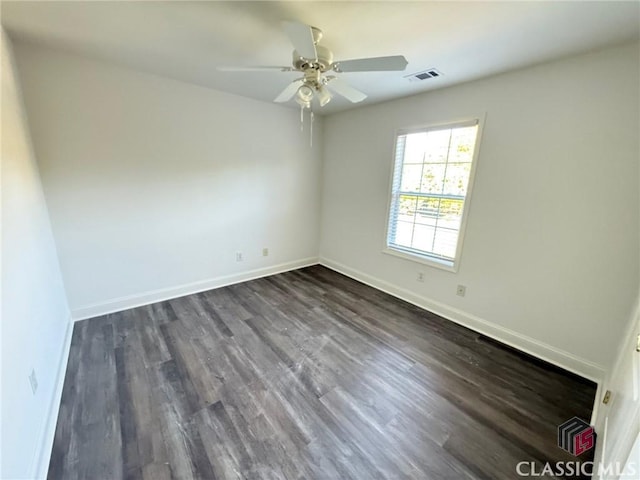 unfurnished room with ceiling fan and dark wood-type flooring