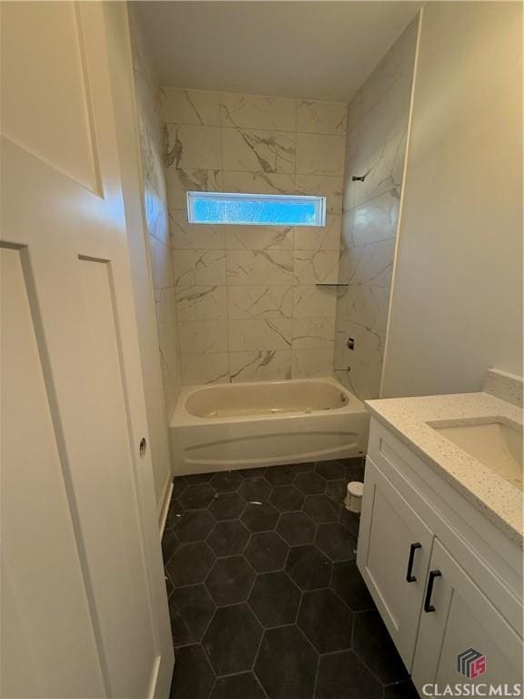 bathroom with vanity, tiled shower / bath combo, and tile patterned flooring