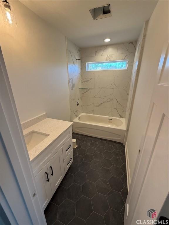 full bathroom featuring vanity, toilet, tile patterned floors, and tiled shower / bath