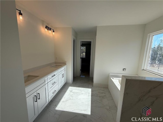 bathroom with vanity and a bath