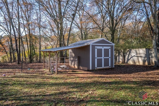 view of shed featuring fence