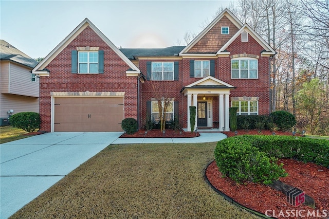 craftsman inspired home with cooling unit, a garage, and a front yard