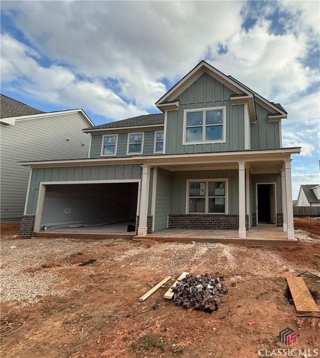 craftsman-style home featuring a porch and a garage