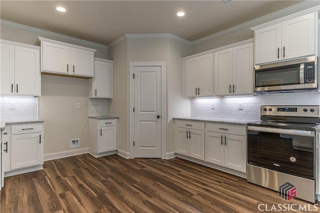 kitchen featuring white cabinetry, appliances with stainless steel finishes, and light stone counters