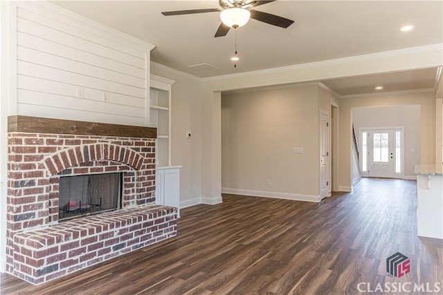 unfurnished living room featuring crown molding, dark wood-type flooring, ceiling fan, and a fireplace