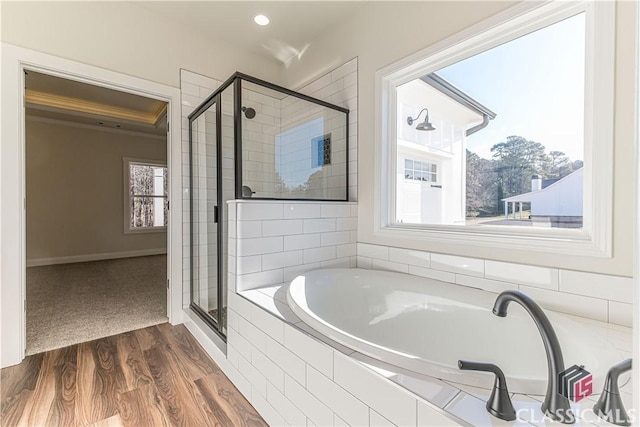 bathroom featuring wood-type flooring and independent shower and bath