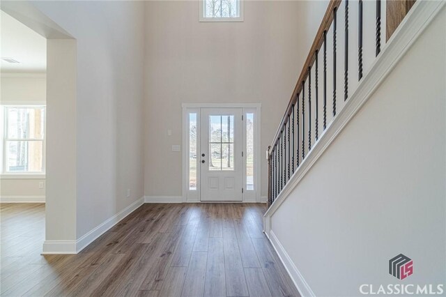 unfurnished dining area with an inviting chandelier, beam ceiling, dark hardwood / wood-style floors, coffered ceiling, and ornamental molding