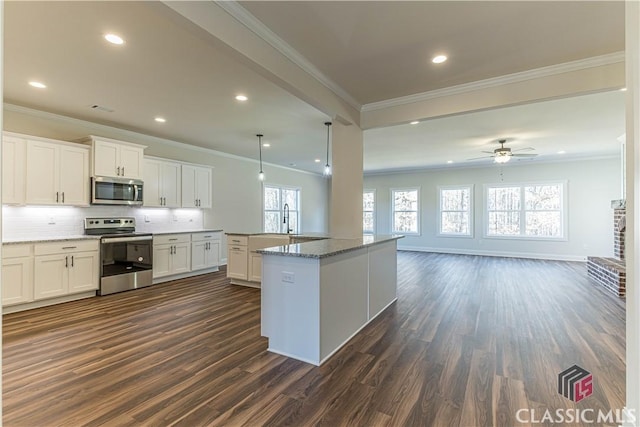 kitchen with white cabinetry, ornamental molding, dark hardwood / wood-style flooring, and stainless steel appliances