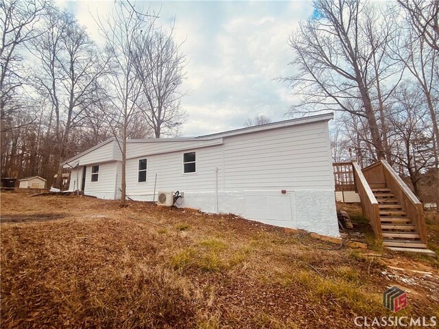 rear view of house featuring ac unit