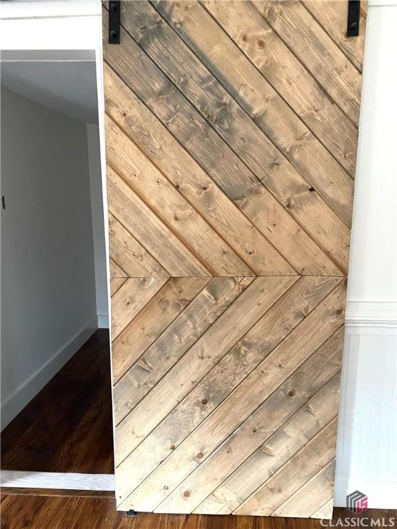 details featuring hardwood / wood-style flooring and a barn door