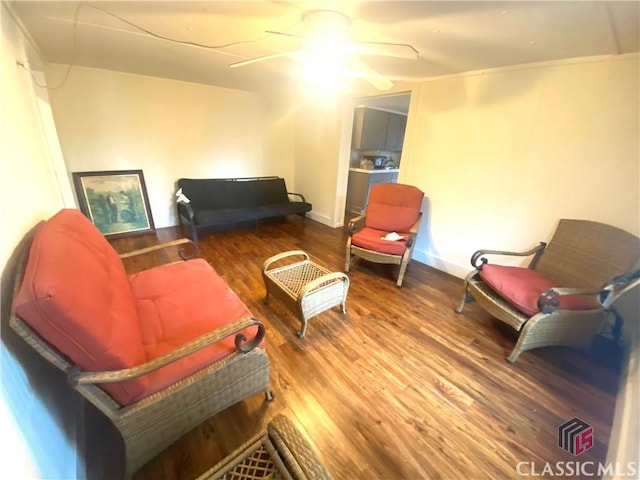 living area with ceiling fan and hardwood / wood-style floors