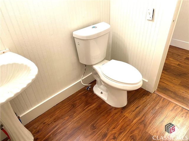 bathroom with toilet and hardwood / wood-style flooring