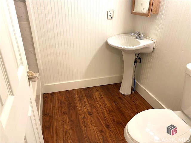 bathroom featuring toilet and hardwood / wood-style flooring