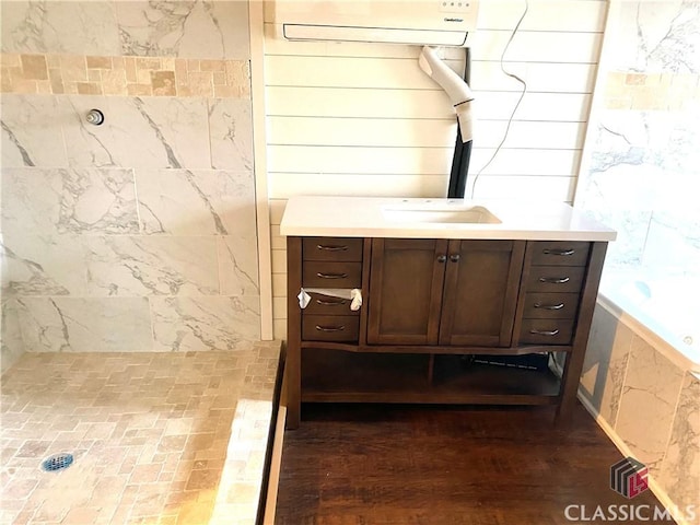 bathroom featuring a shower and vanity