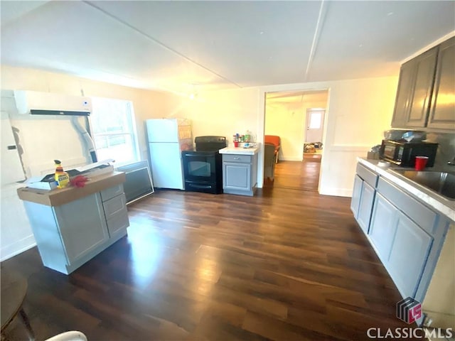 kitchen featuring black appliances, sink, gray cabinets, and dark hardwood / wood-style floors