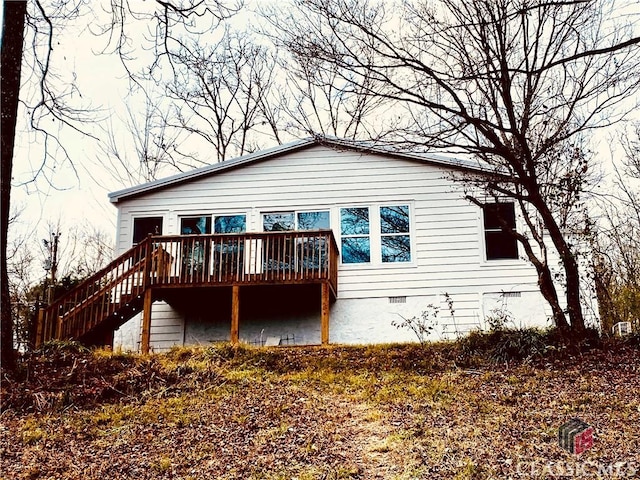 back of house featuring a wooden deck