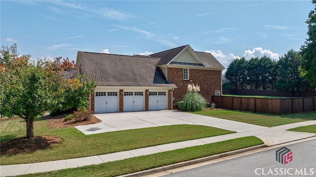 front facade featuring a garage and a front lawn