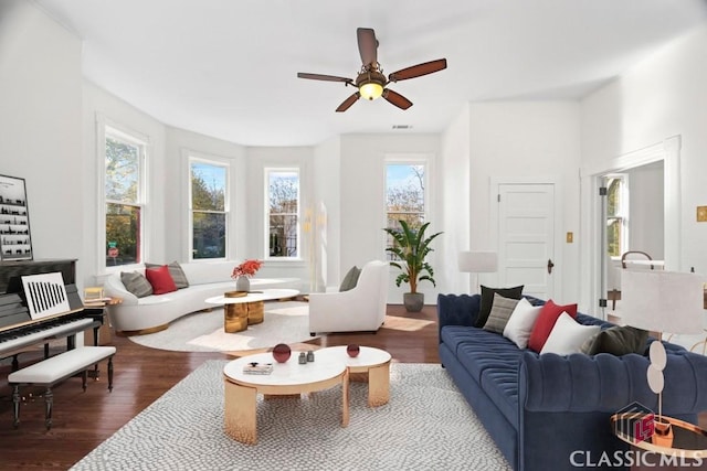 living area with ceiling fan, dark wood-type flooring, and visible vents