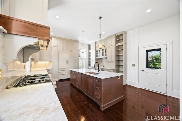 kitchen with open shelves, gas range, recessed lighting, and a sink