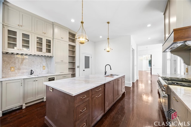 kitchen featuring high end stainless steel range oven, a sink, recessed lighting, and dark wood finished floors