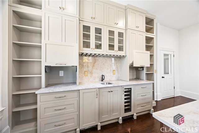 kitchen with wine cooler, a sink, tasteful backsplash, baseboards, and open shelves