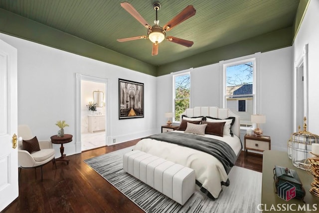 bedroom with wood-type flooring, ensuite bathroom, and ceiling fan