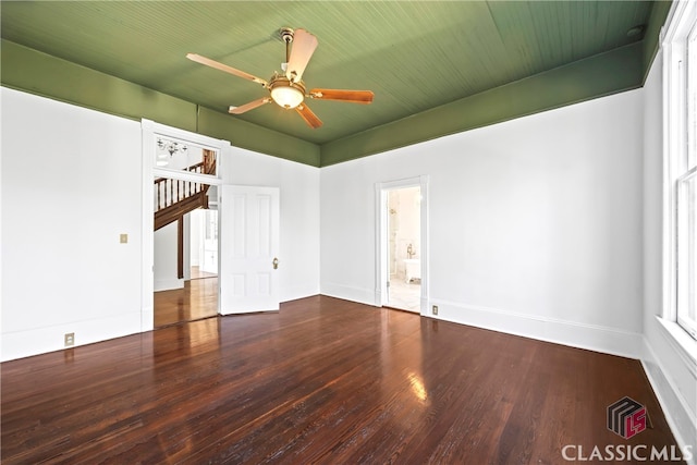 unfurnished room with baseboards, a ceiling fan, and wood finished floors