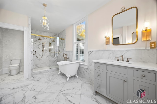 bathroom featuring a marble finish shower, wainscoting, vanity, marble finish floor, and toilet