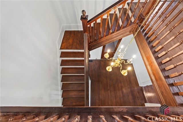 stairs with a notable chandelier