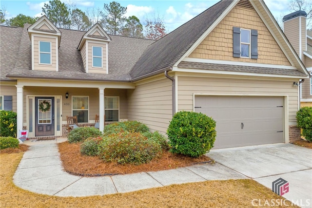 view of front of house featuring covered porch and a garage