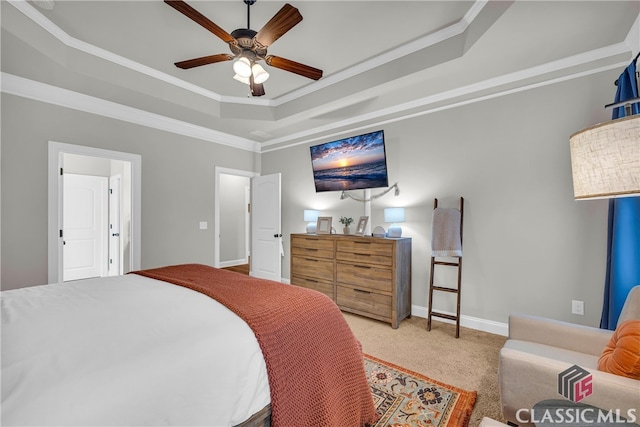 bedroom featuring carpet floors, crown molding, a raised ceiling, ceiling fan, and baseboards