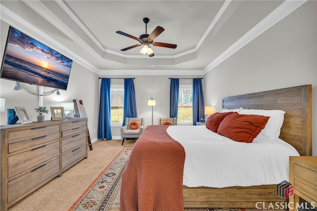 carpeted bedroom with ceiling fan, ornamental molding, a raised ceiling, and baseboards