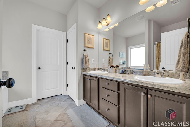 full bath featuring double vanity, tile patterned flooring, a sink, and visible vents