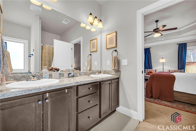 bathroom with ensuite bathroom, double vanity, a sink, and visible vents