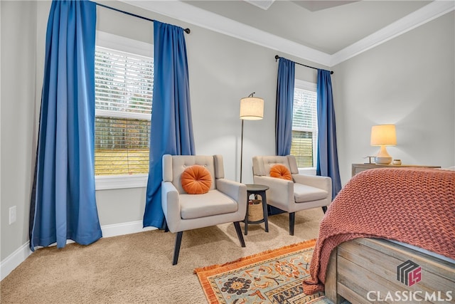 carpeted bedroom with ornamental molding and baseboards