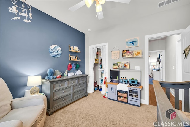 rec room with ceiling fan, carpet floors, visible vents, and attic access