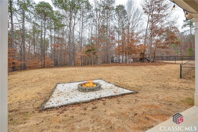 view of yard featuring an outdoor fire pit and a fenced backyard